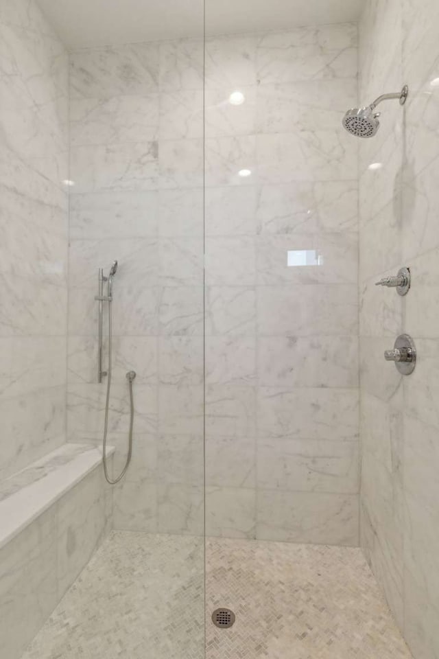 bathroom with tiled shower