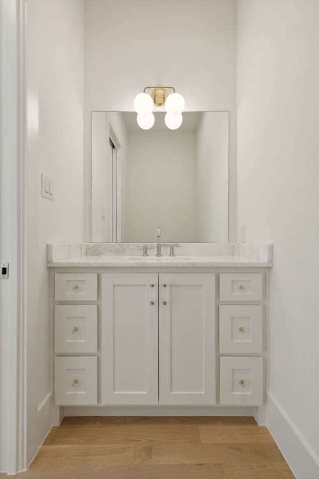 bathroom with vanity and hardwood / wood-style floors