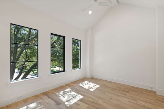 empty room with lofted ceiling with beams, light wood-type flooring, and ceiling fan