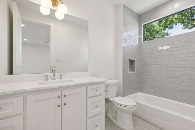 full bathroom featuring vanity, toilet, and tiled shower / bath