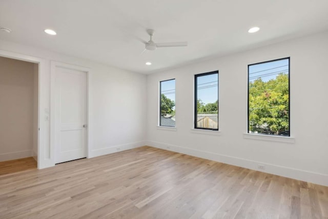 unfurnished room with light wood-type flooring and ceiling fan