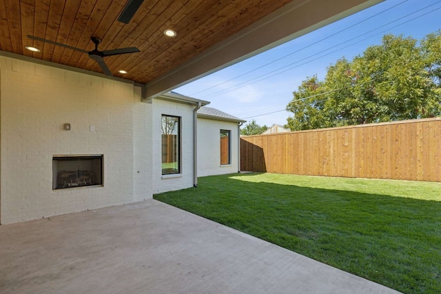 view of yard with ceiling fan and a patio area