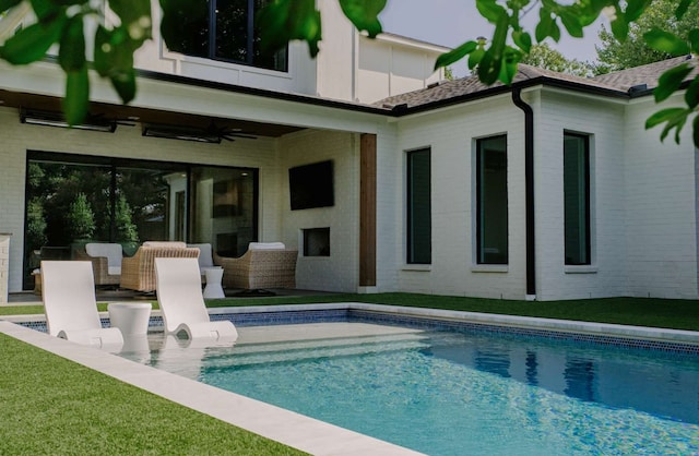 back of house featuring ceiling fan, a patio area, and a yard