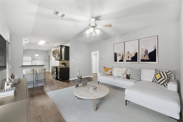 living room with ceiling fan and hardwood / wood-style flooring