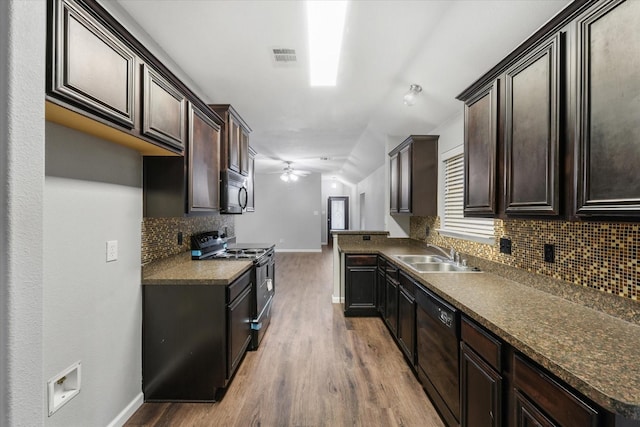 kitchen with wood-type flooring, black appliances, ceiling fan, sink, and backsplash