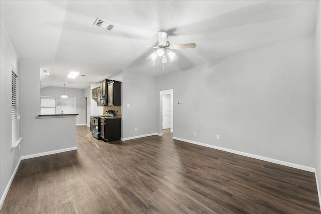 unfurnished living room featuring ceiling fan, vaulted ceiling, and dark hardwood / wood-style floors