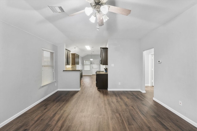 unfurnished living room featuring lofted ceiling, ceiling fan, and dark hardwood / wood-style floors