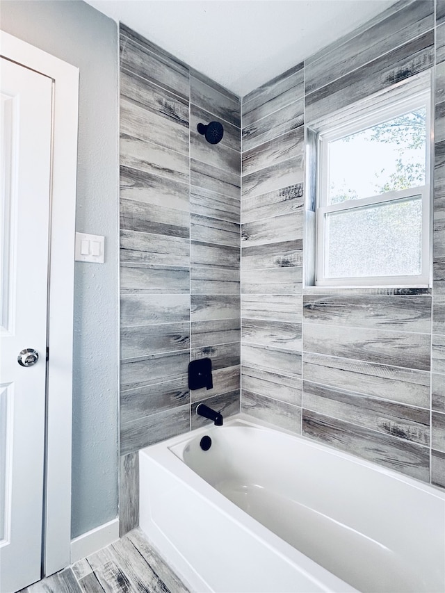 bathroom featuring tiled shower / bath combo and hardwood / wood-style floors