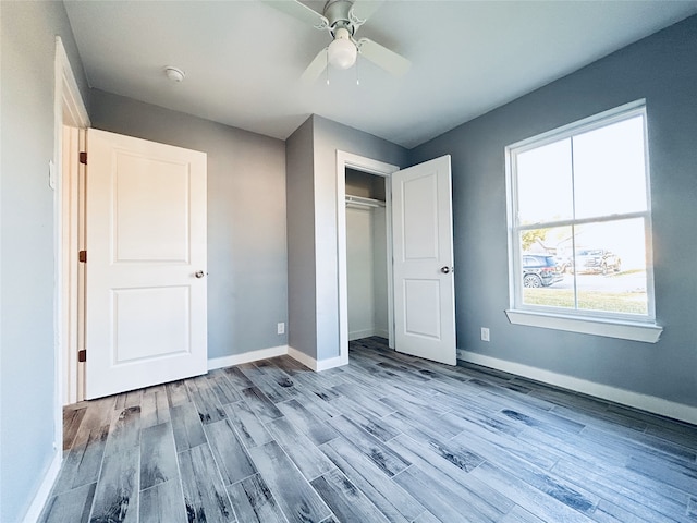 unfurnished bedroom featuring ceiling fan, a closet, and light hardwood / wood-style floors