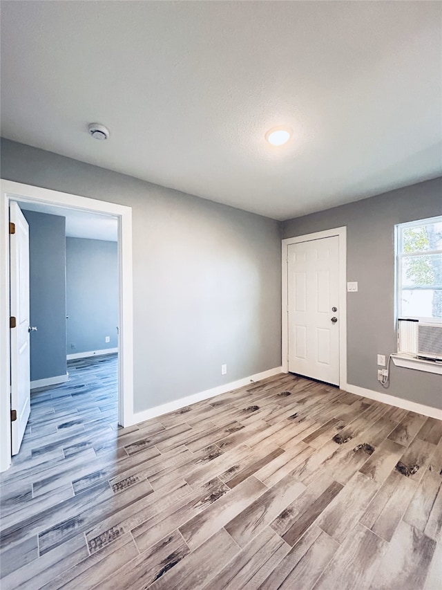 spare room featuring light wood-type flooring and cooling unit