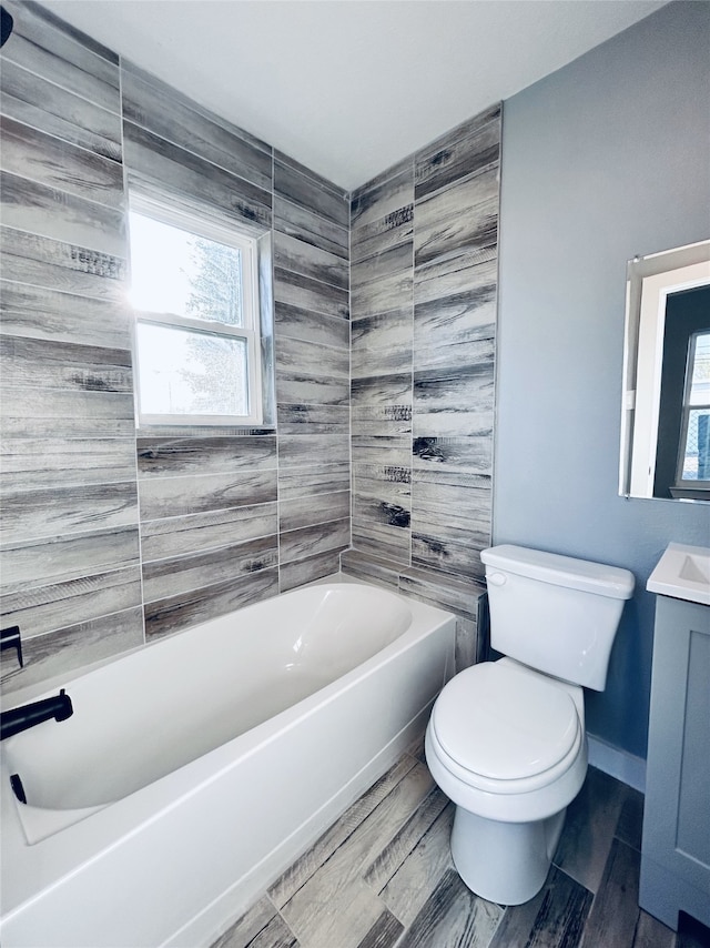 bathroom with tile walls, vanity, toilet, and hardwood / wood-style flooring