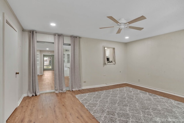 spare room featuring light hardwood / wood-style floors and ceiling fan