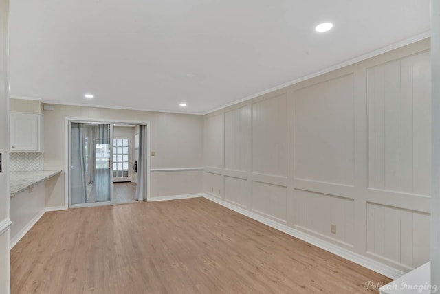 interior space featuring light wood-type flooring and crown molding