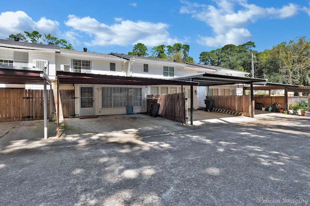 back of property with a carport