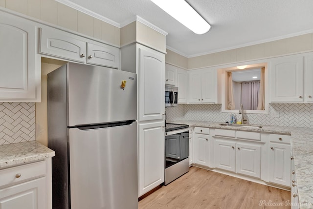 kitchen with white cabinets, stainless steel appliances, and sink