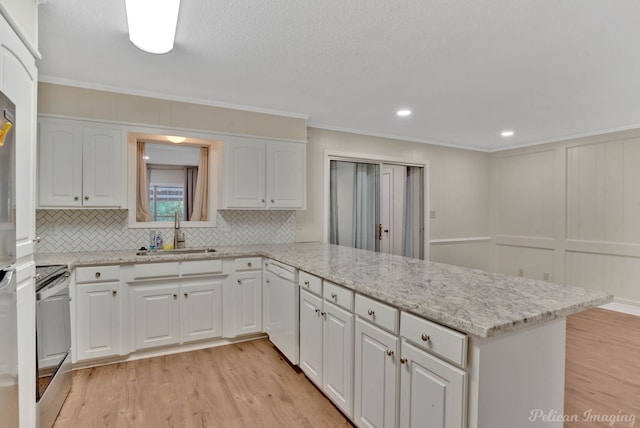 kitchen with white dishwasher, sink, kitchen peninsula, white cabinetry, and light wood-type flooring