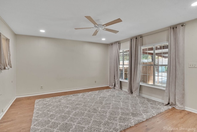 empty room featuring ceiling fan and light hardwood / wood-style flooring