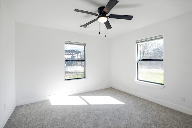 unfurnished room with carpet, ceiling fan, and a healthy amount of sunlight