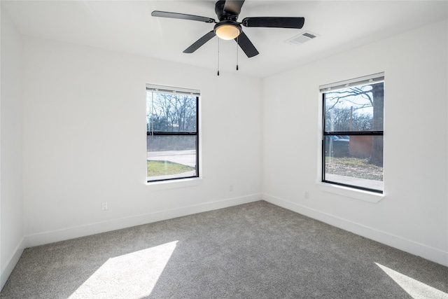 unfurnished room with ceiling fan, carpet floors, and a wealth of natural light