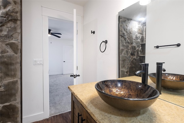 bathroom featuring ceiling fan, hardwood / wood-style floors, and vanity