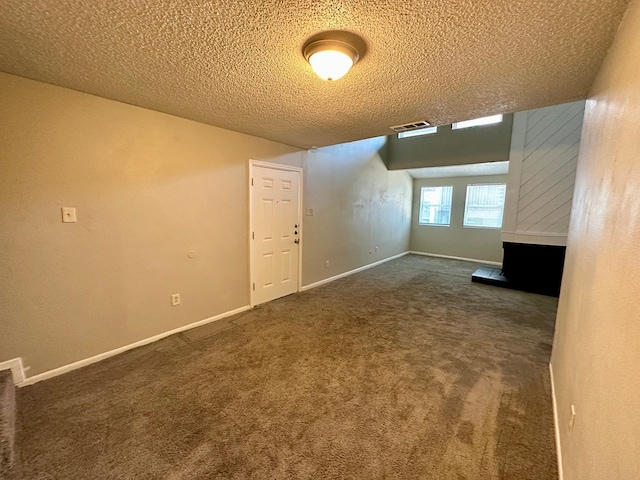 carpeted spare room featuring a textured ceiling