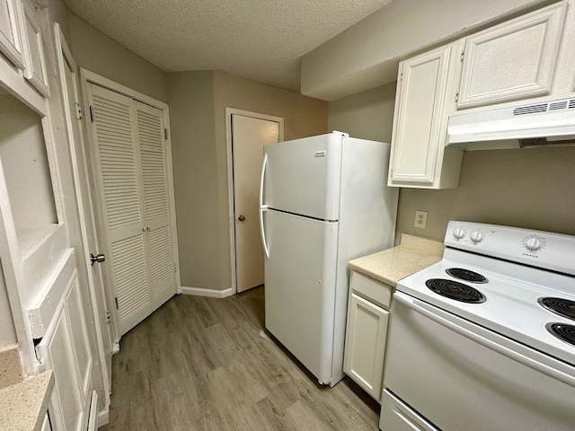 kitchen with ventilation hood, light hardwood / wood-style floors, white appliances, and white cabinetry