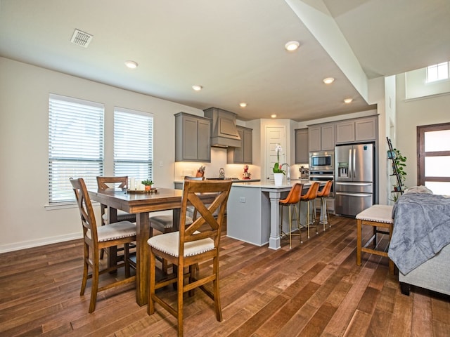 dining space with dark hardwood / wood-style floors and plenty of natural light