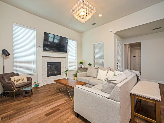 living room featuring a notable chandelier, plenty of natural light, and hardwood / wood-style flooring