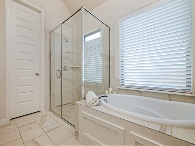 bathroom featuring a healthy amount of sunlight and plus walk in shower