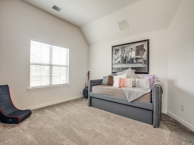 carpeted bedroom with lofted ceiling