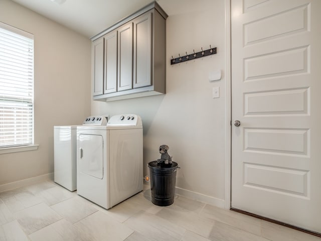 laundry room with cabinets and washing machine and clothes dryer