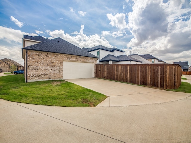 view of property exterior featuring a lawn and a garage