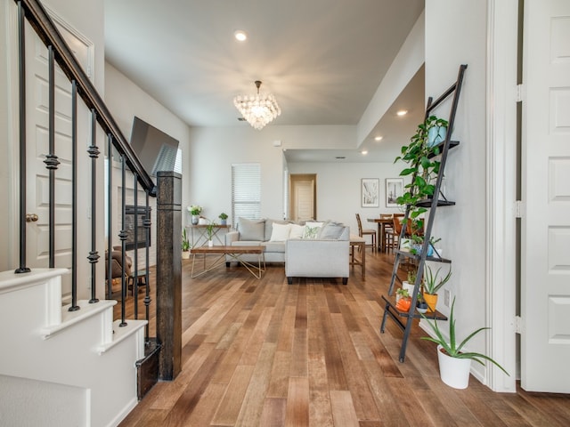 interior space featuring wood-type flooring and a notable chandelier