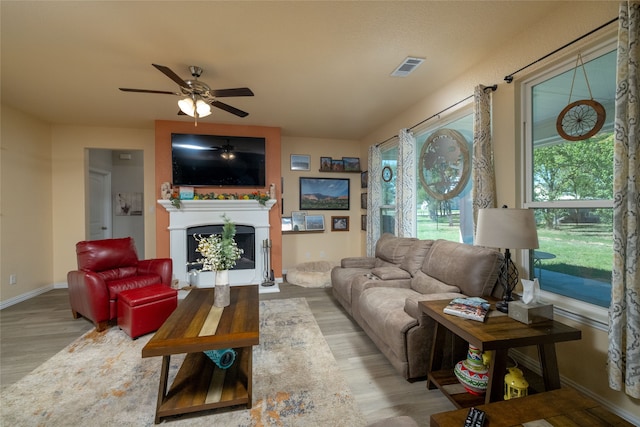 living room featuring hardwood / wood-style floors and ceiling fan