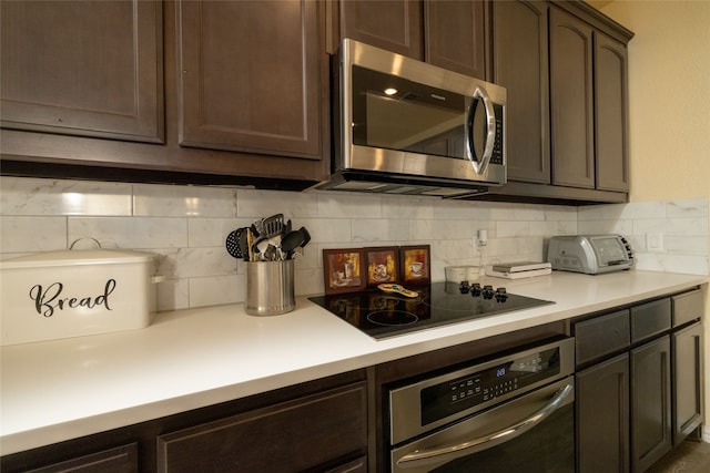 kitchen with appliances with stainless steel finishes, dark brown cabinets, and tasteful backsplash