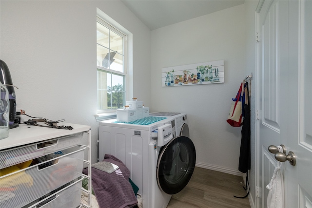 laundry area featuring light hardwood / wood-style floors and washing machine and clothes dryer