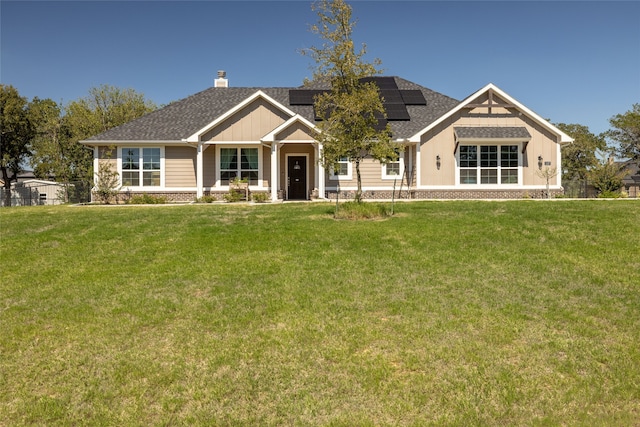 craftsman house with solar panels and a front yard