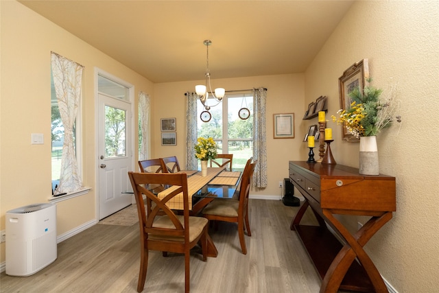 dining room with hardwood / wood-style floors and a chandelier