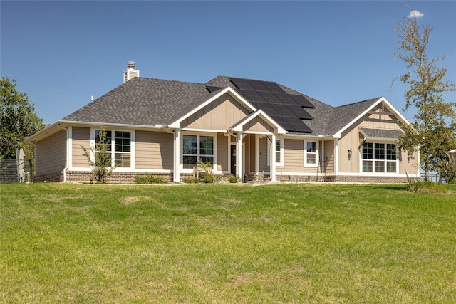 craftsman house with solar panels and a front yard