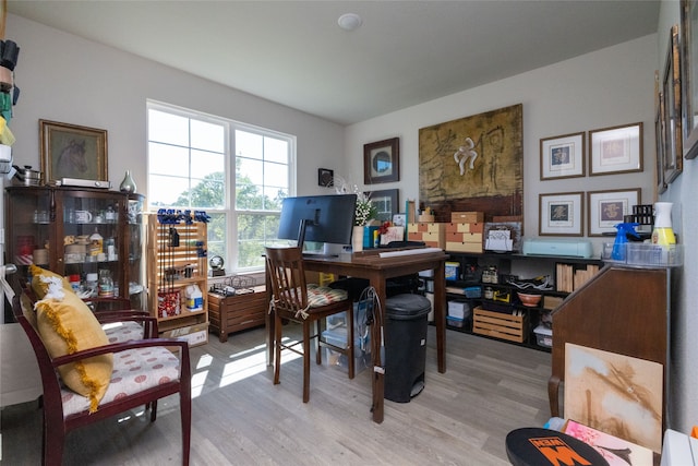 home office with light hardwood / wood-style floors