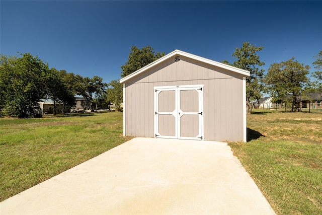 view of outbuilding with a lawn