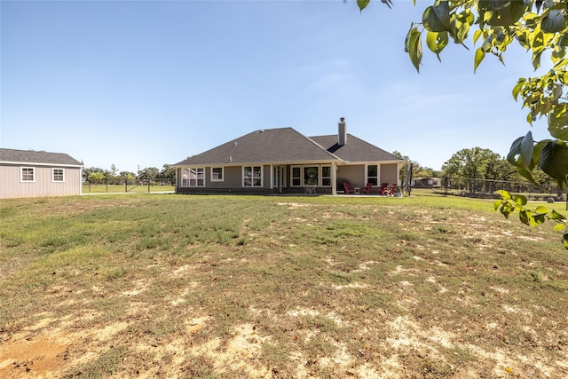 back of house featuring a lawn