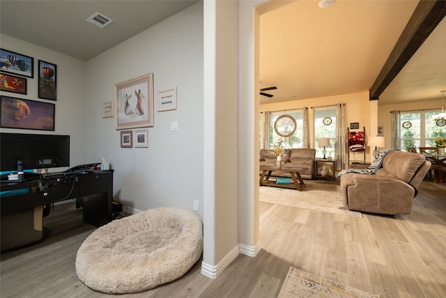 home office with wood-type flooring, ceiling fan, and a healthy amount of sunlight