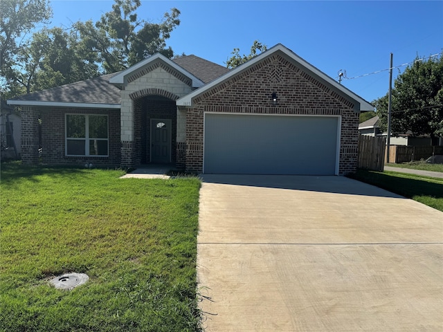 view of front of property with a front yard and a garage