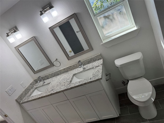 bathroom featuring tile patterned flooring, vanity, and toilet