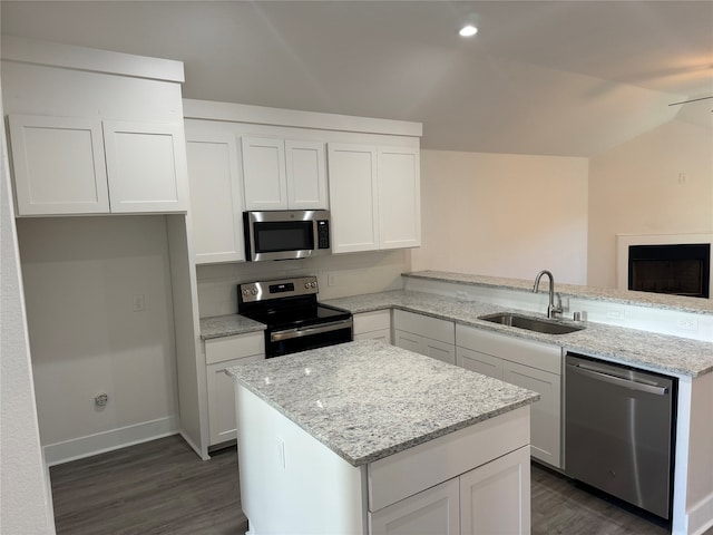 kitchen with appliances with stainless steel finishes, white cabinetry, and sink