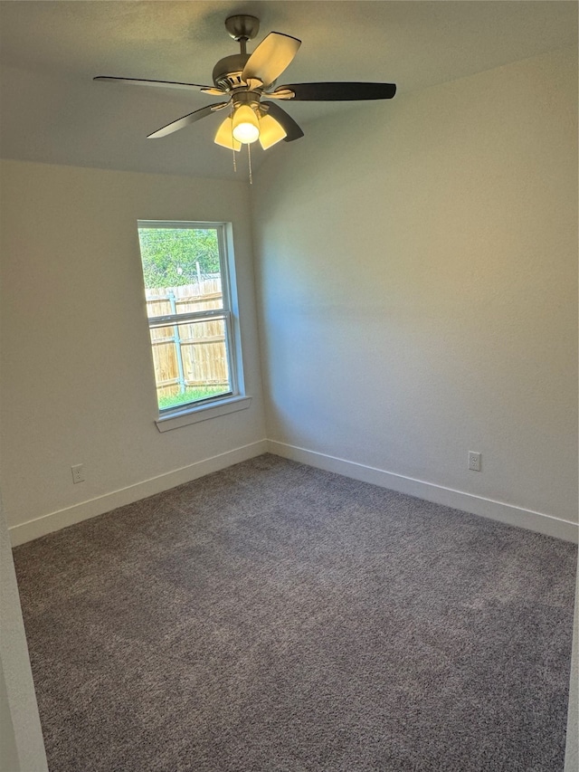 carpeted spare room with ceiling fan