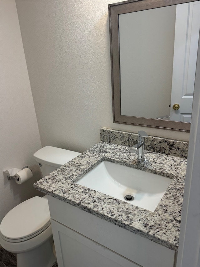 bathroom with vanity and toilet