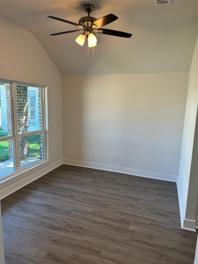 empty room with vaulted ceiling, dark wood-type flooring, and ceiling fan