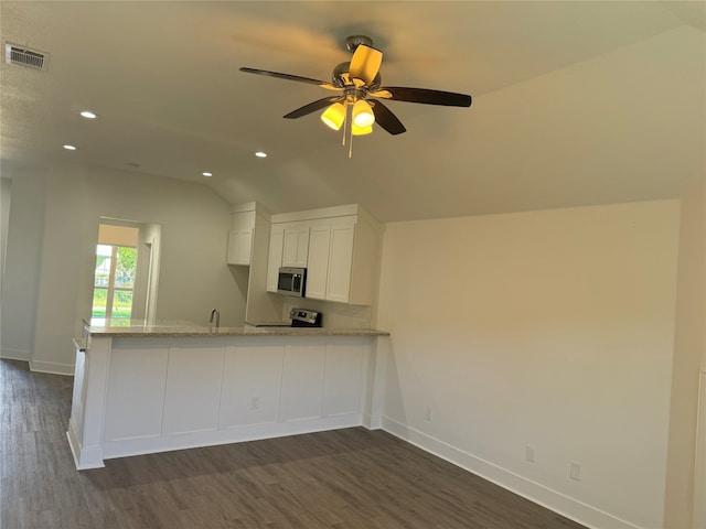 kitchen with ceiling fan, white cabinetry, stainless steel appliances, light stone countertops, and vaulted ceiling